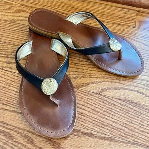 Black and gold report flip flops